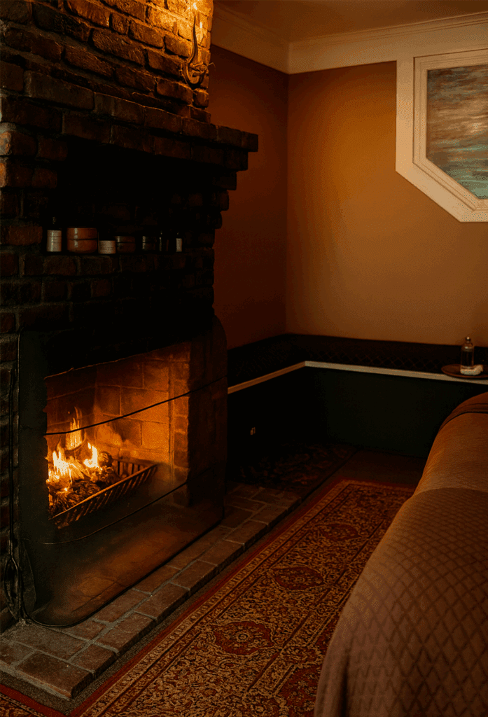 Lit fireplace in a treatment room at Massage Grotto SF with a warm and relaxing atmosphere.